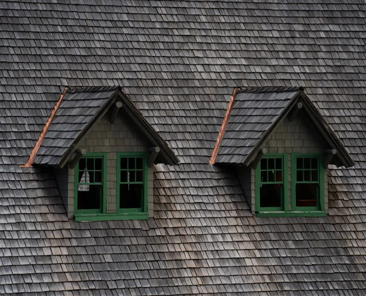 Dormers on a shingle roof in Torrance, CA, where step flashing and kickout flashing carry water past the walls